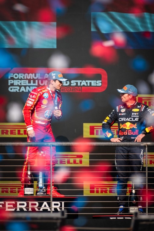 Charles Leclerc and Max Verstappen exchange words at the podium of the 2024 United States Grand Prix while showered in confetti