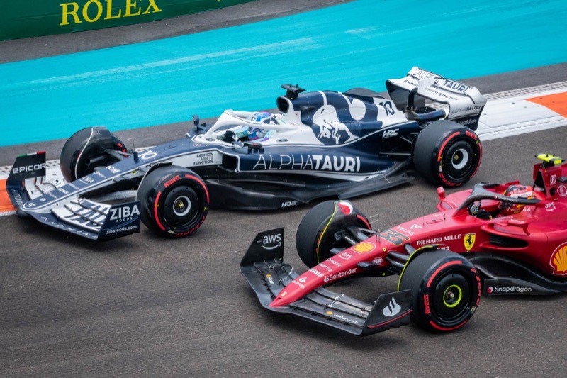 An AlphaTauri and a Ferrari Formula 1 car racing side by side at the Miami Grand Prix