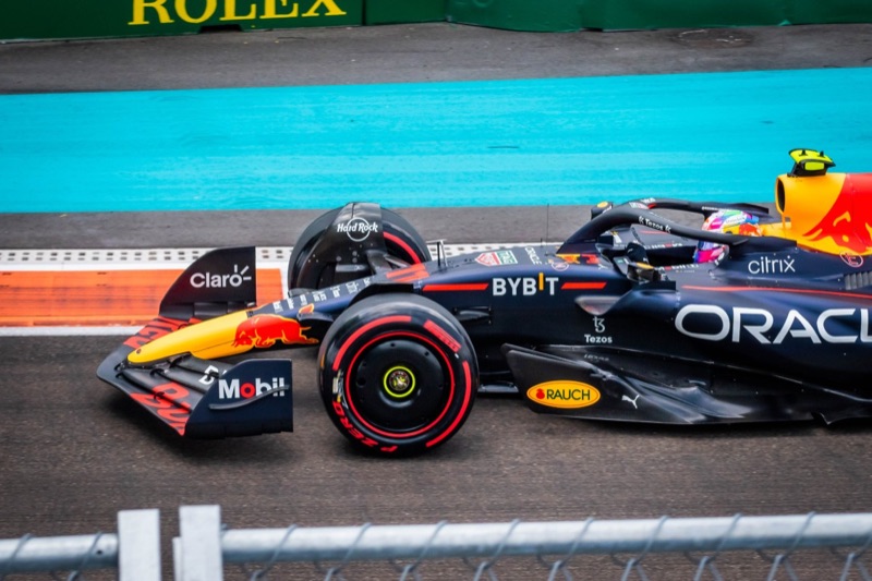 An Oracle Red Bull Formula 1 car cornering beside the turquoise runoff at the Miami Grand Prix