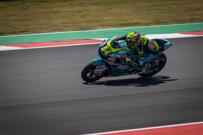 Moto2 rider Fermin Aldeguer, number 54, leaning into a corner with knee down at speed