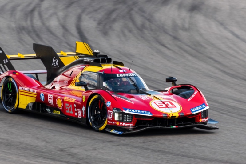 The number 51 Ferrari 499P Le Mans Hypercar cornering, front three-quarter view
