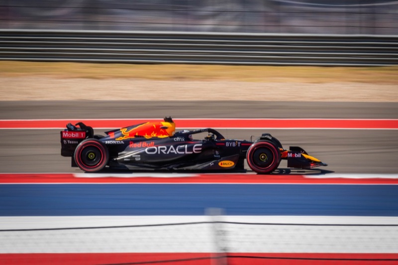 An Oracle Red Bull Formula 1 car driven by Max Verstappen at speed in profile, at the Circuit of the Americas
