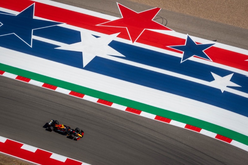 Overhead view of a Red Bull Formula 1 car driven by Sergio Perez passing the star-spangled red, white and blue runoff at the Circuit of the Americas