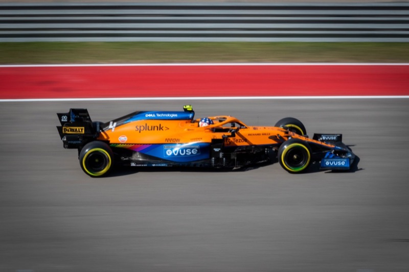 Lando Norris drives his McLaren MCL34, captured from the side with a blurred background